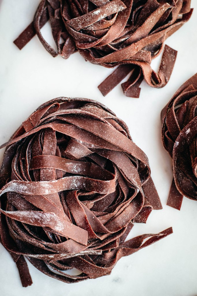 Fresh pasta is a labour of love and great pasta needs practice: these homemade cocoa tagliatelle are a wonderful way to step-up your pasta game pairing a very basic shape with cocoa powder and its characteristic flavours and colour. Delicious when served with melted cheese and spices, this fresh pasta with cocoa will definitely surprise you with its special taste.