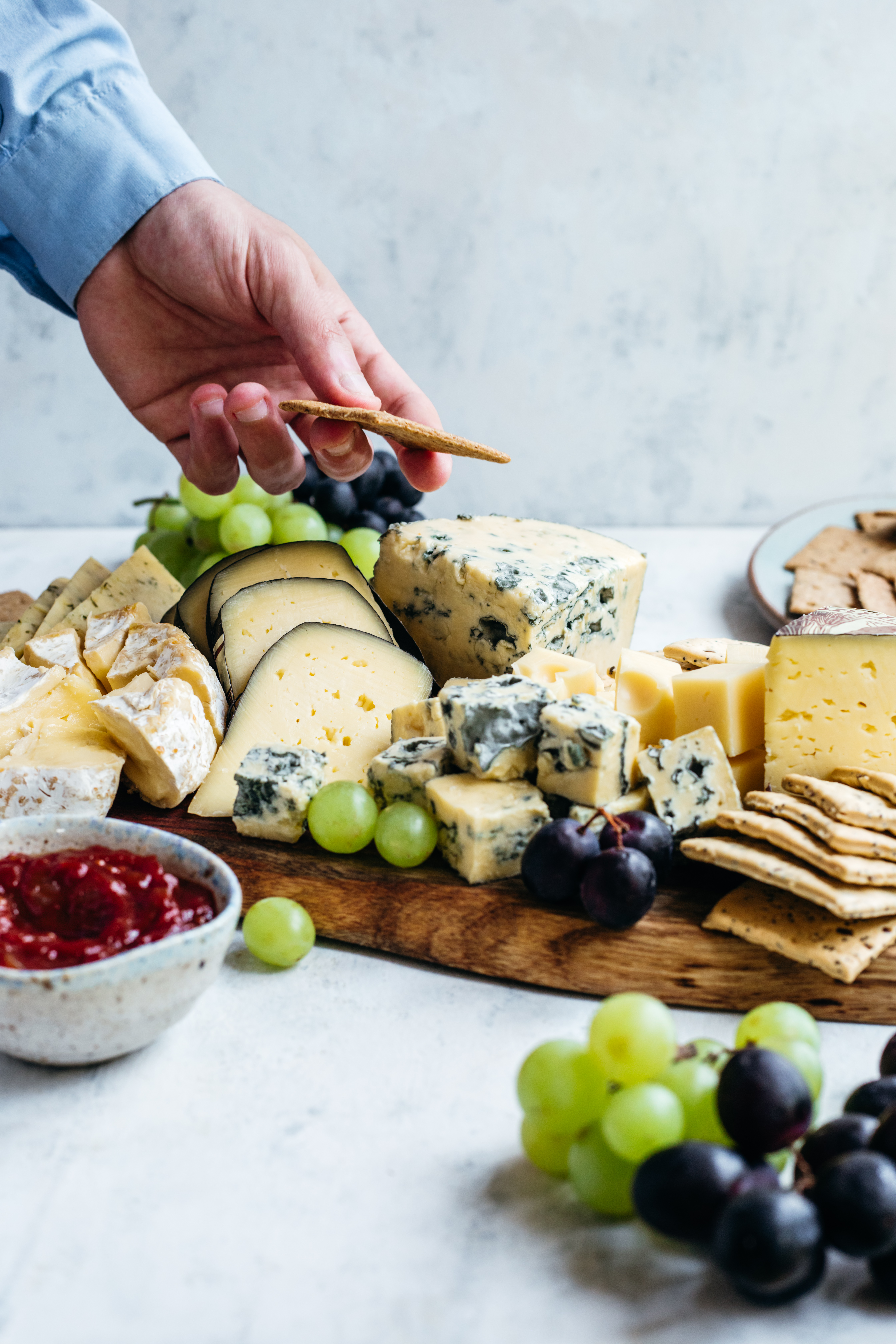 Cheese board with a selection of Irish artisan cheese, grapes and tomato relish