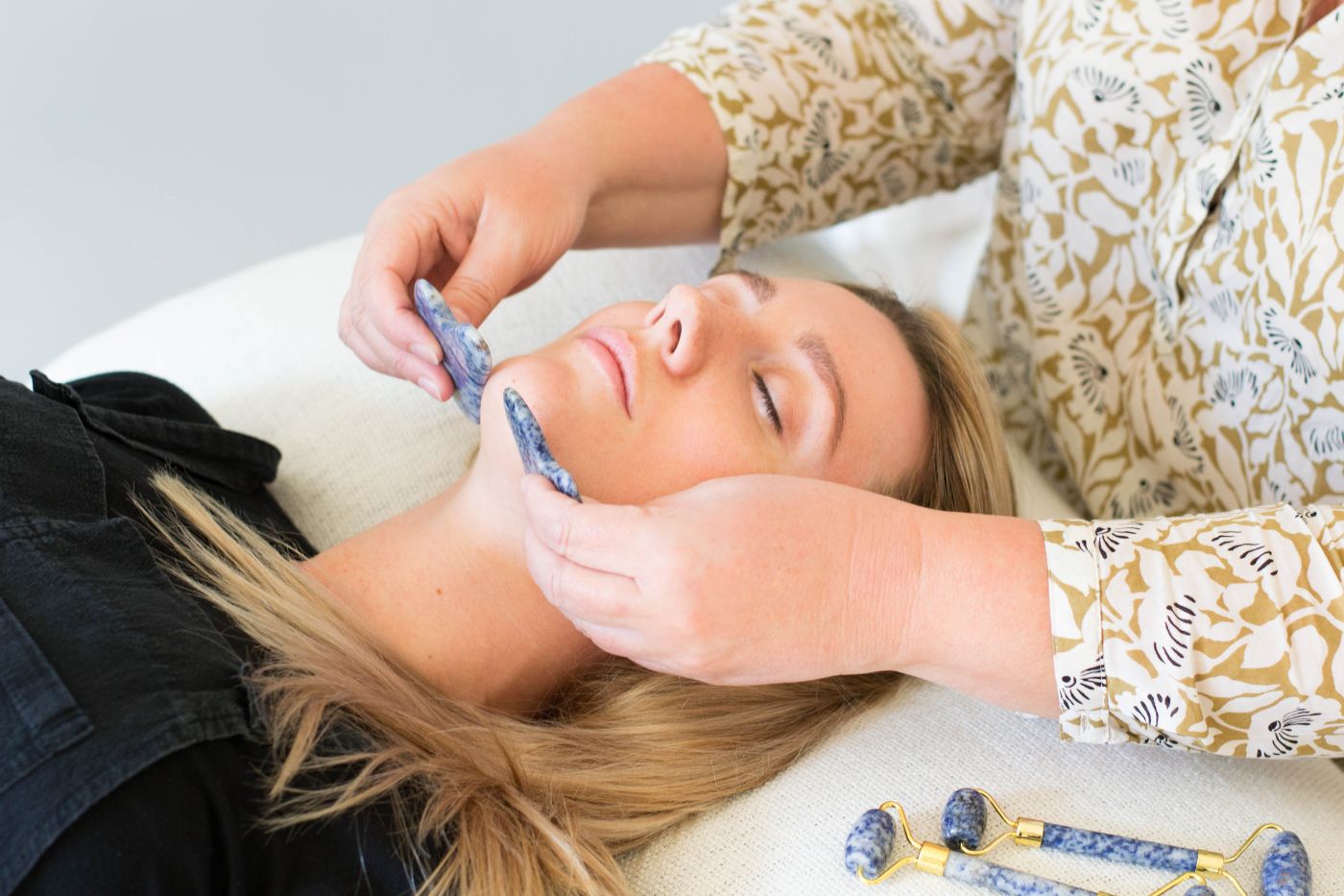 Woman receiving a gua sha facial. Dublin brand photography by Chiara Gianelli.