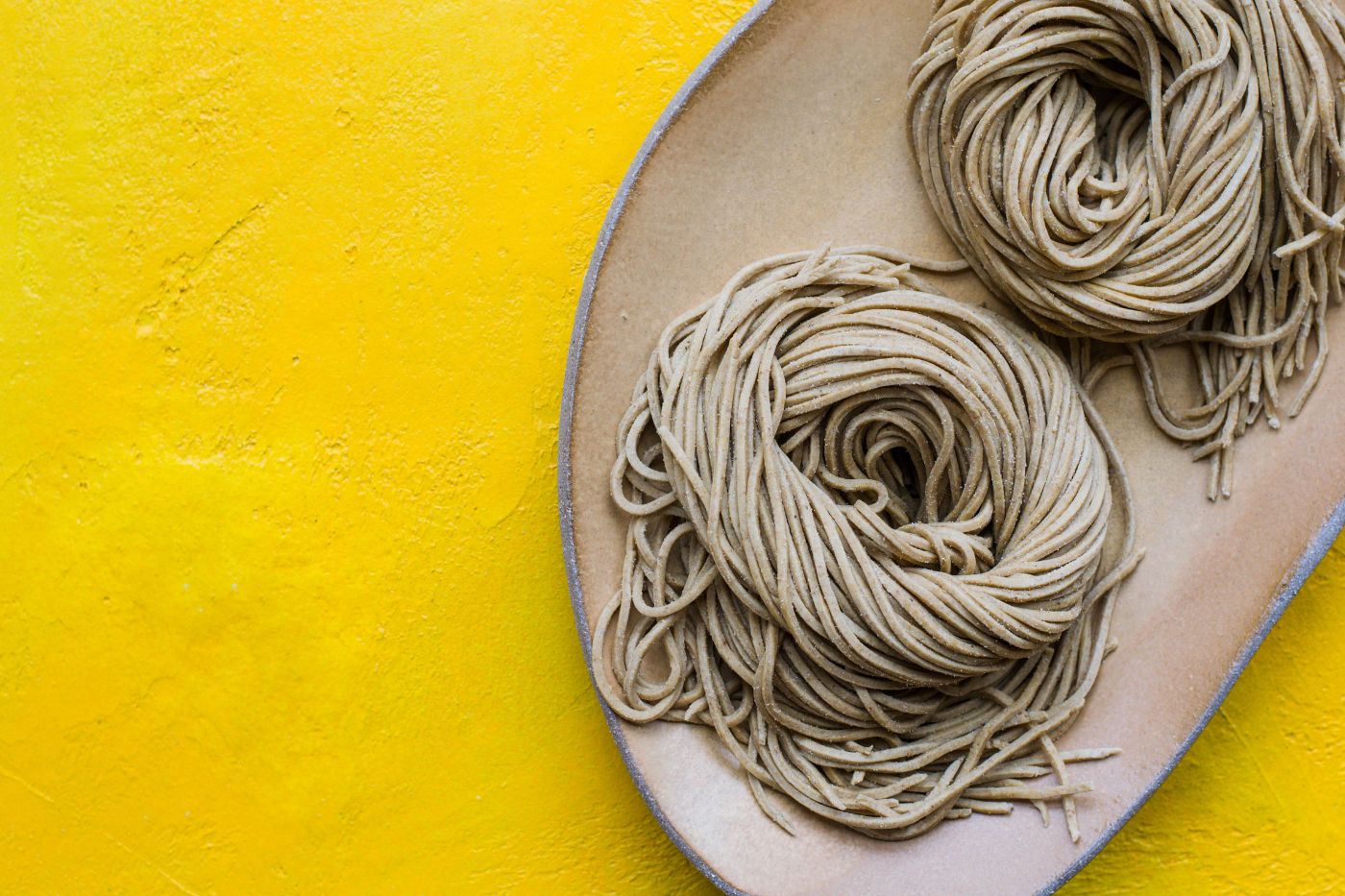 Handmade noodles on a yellow background