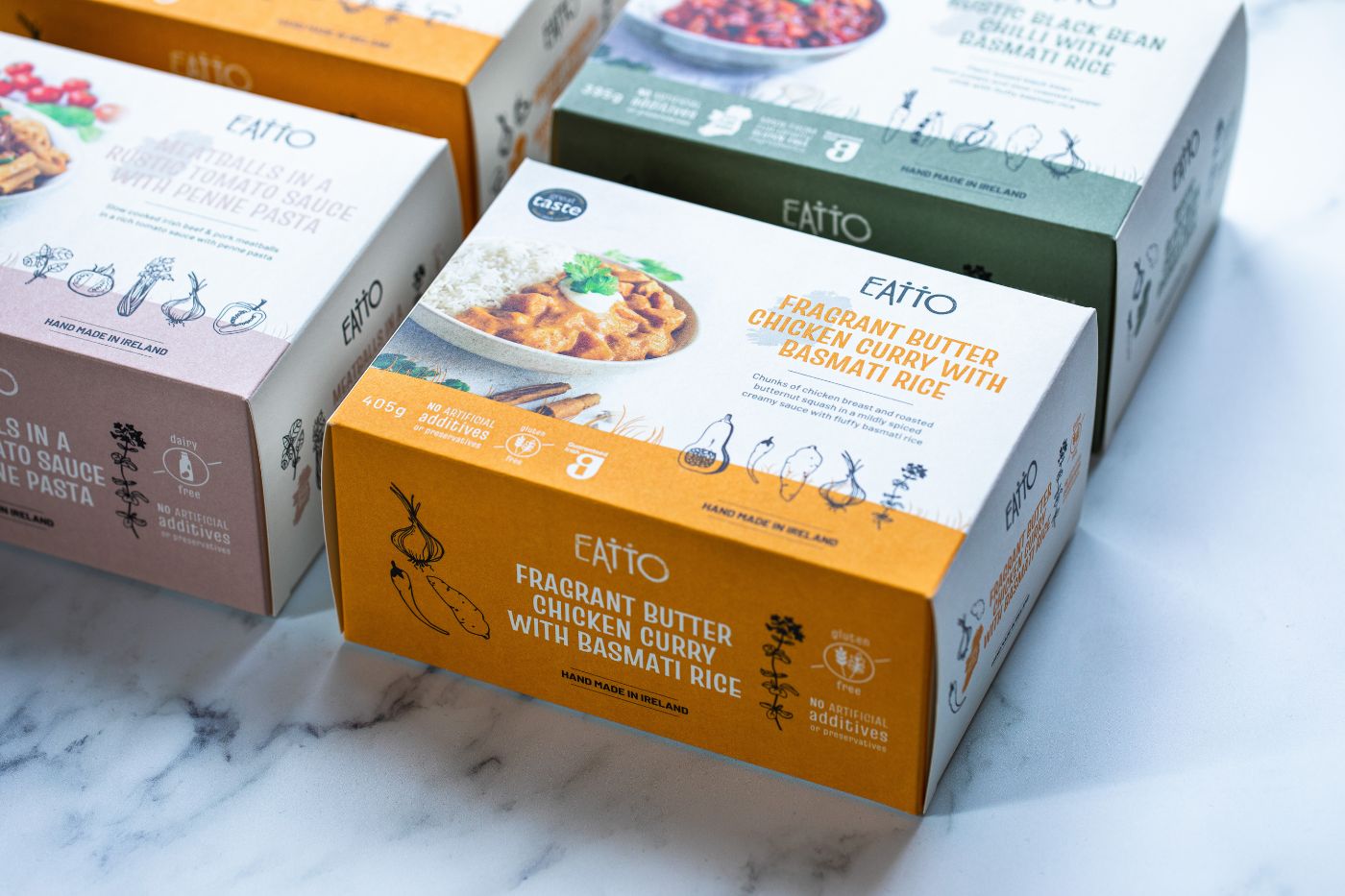 Product photo of boxes of frozen meals with different colours and food photos on them.