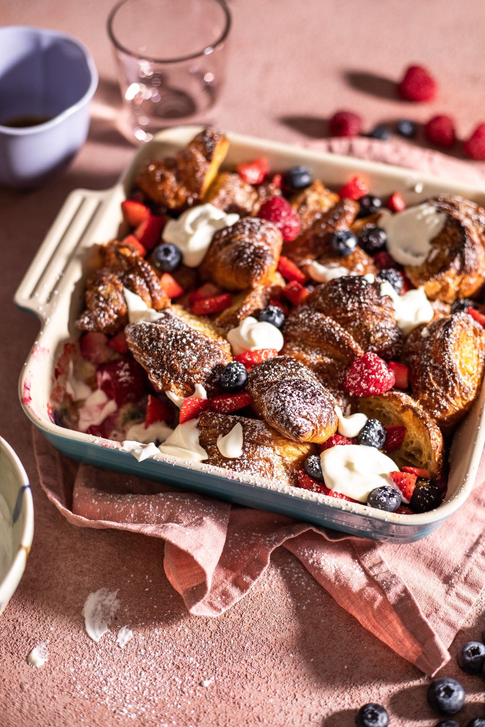 Baked croissant French toast served with berries and yogurt. Food photography and styling by Chiara Gianelli