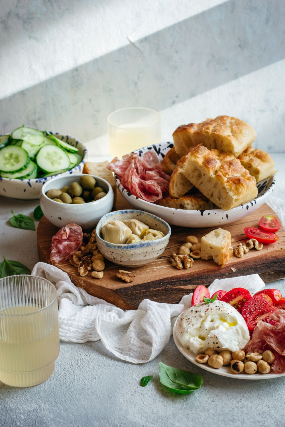 Charcuterie board with fresh focaccia, mozzarella, olives, nuts, salami and veggies styled by Dublin food photographer Chiara Gianelli